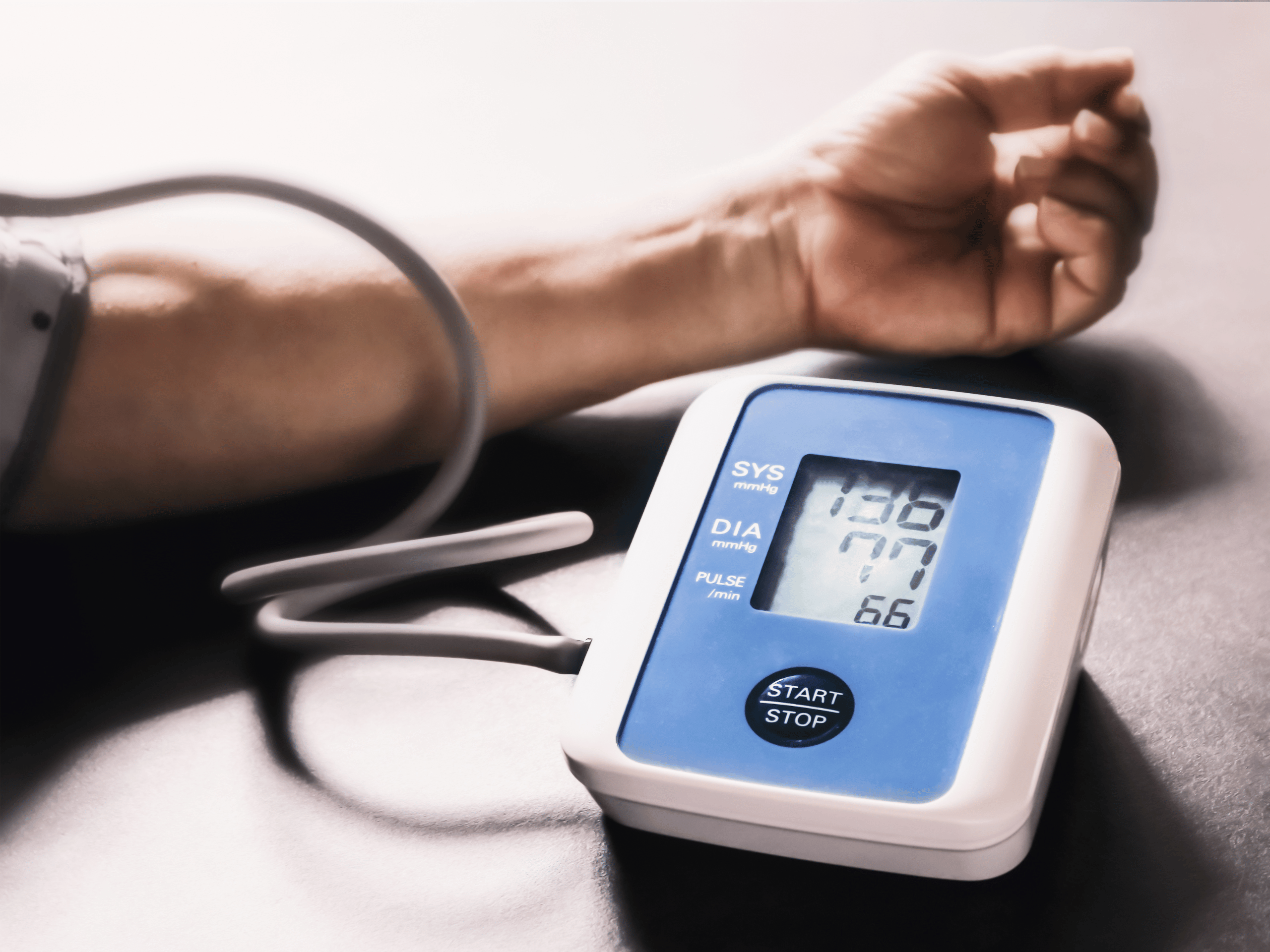 An automatic blood pressure cuff taking a measurement on a man's arm