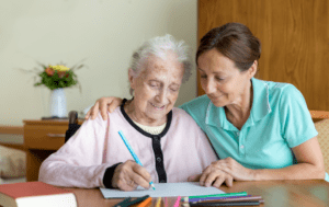 A caregiver providing support to an elderly woman