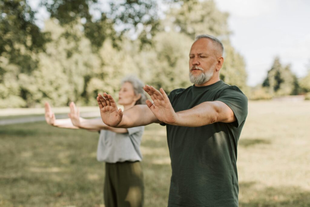 A couple doing Tai Chi in the woods