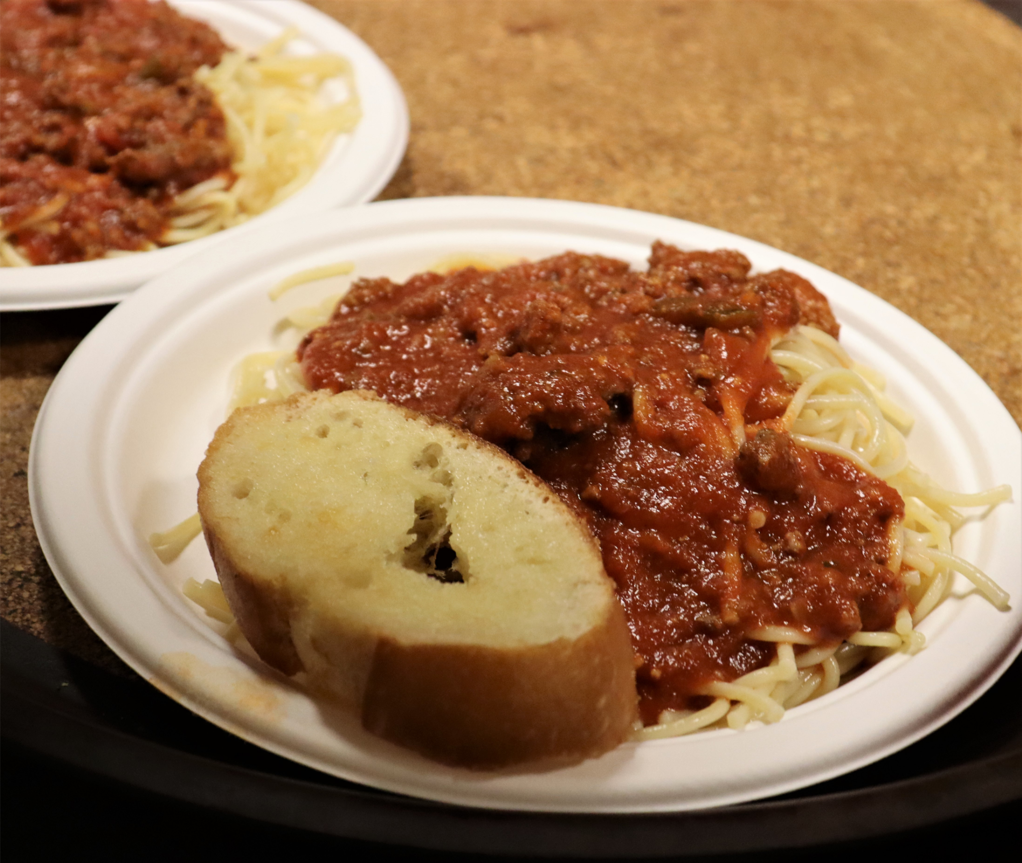 garlic bread and spaghetti with sauce on a plate